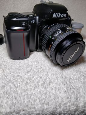 Nikon N6006 35mm autofocus SLR film camera. With Extra Lens and 2 Rolls Of Film.